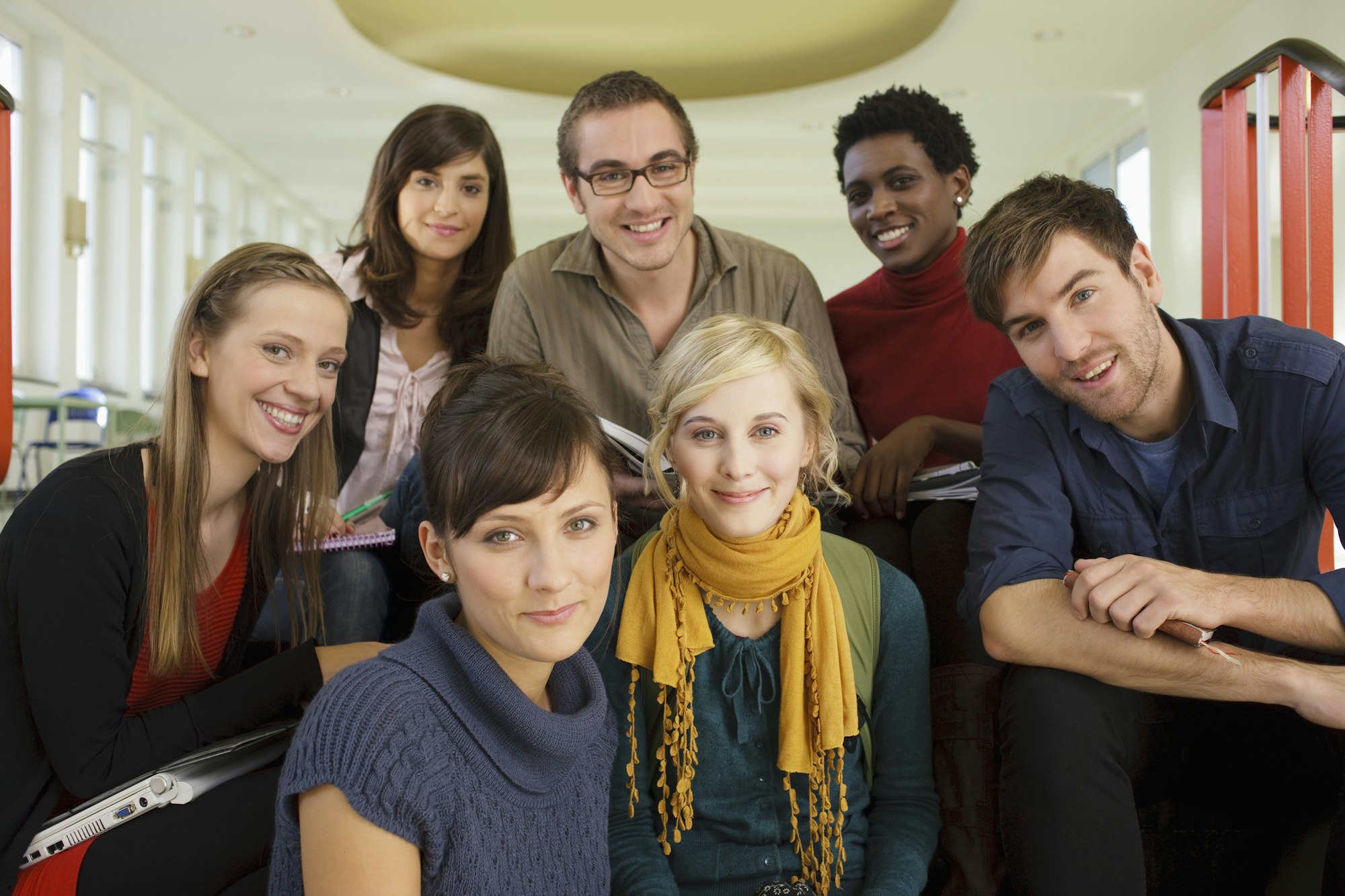 Germany, Leipzig, Group of university students sitting together, smiling, portrait