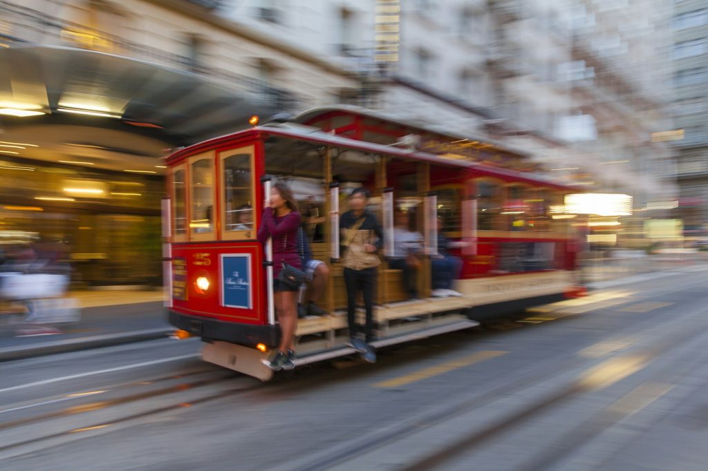 People riding a tram in San Francisco, USA